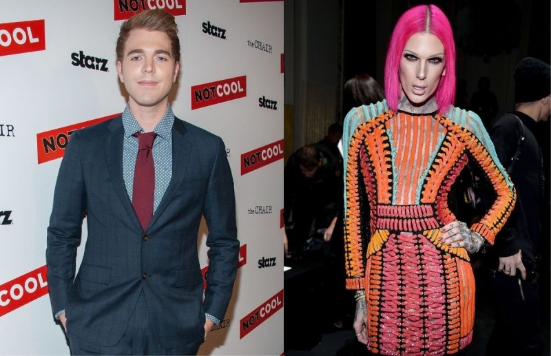 Shane Dawson wearing a dark blue suit on the red carpet. Jeffree Star in a multicolored dress backst