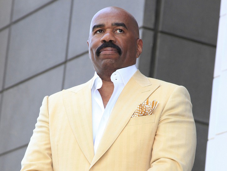 Steve Harvey wears a yellow suit at his Hollywood Walk Of Fame ceremony