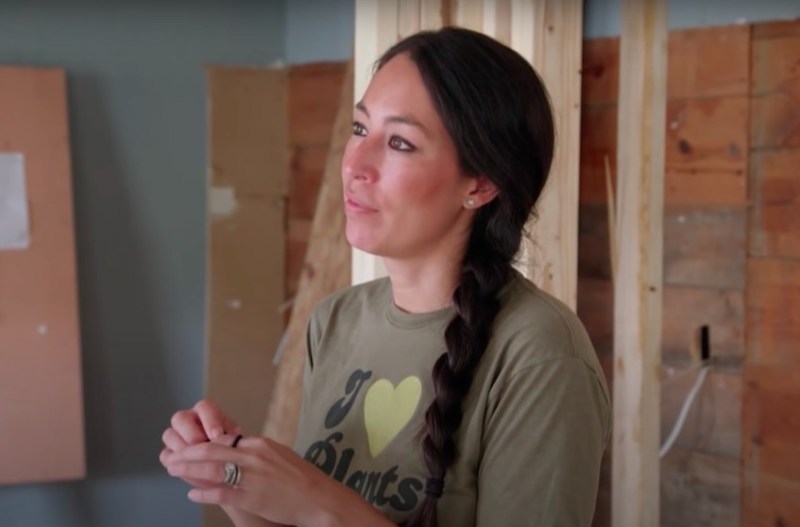 still of Joanna Gaines wearing an olive shirt in an under construction home from Fixer Upper