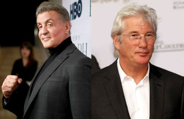 Sylvester Stallone on the red carpet in a dark gray suit. Richard Gere in a black suit and white shi