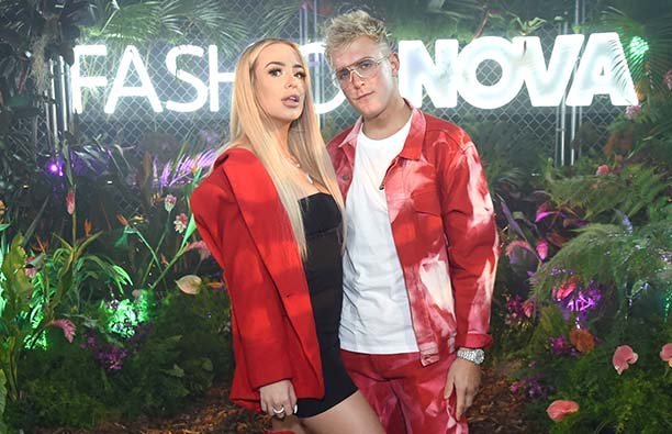 Tana Mongeau and Logan Paul in matching rred outfits.