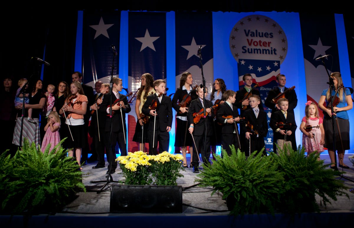 The Duggar family on stage at a political event