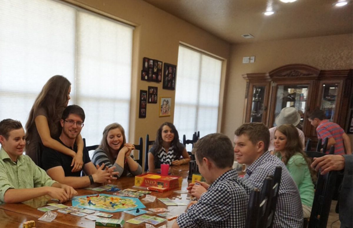 The Duggar family siblings sitting at their kitchen table in their Arkansas home