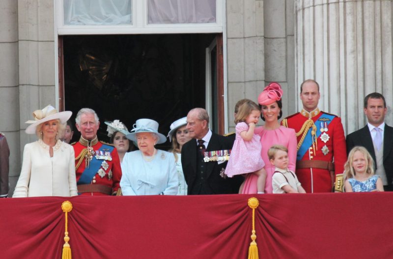 The royal family on a balcony at Buckingham Palace, including Queen Elizabeth, Prince Philip, Prince Charles, Prince William, Kate Middleton, and their children.