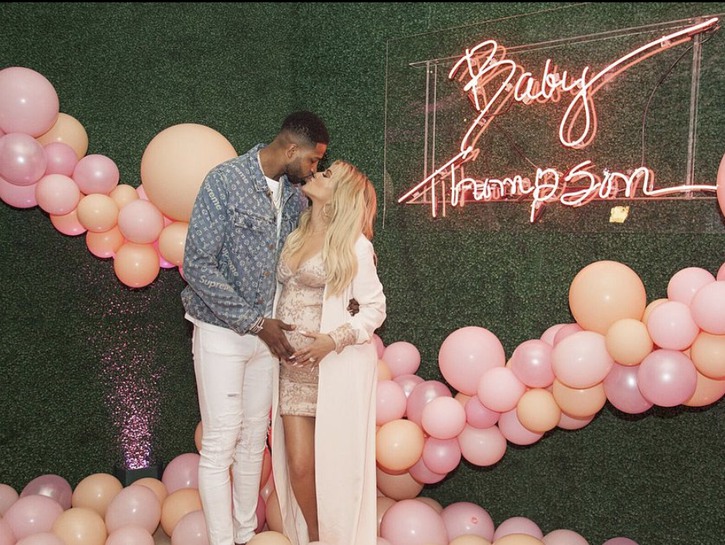 Tristan Thompson and Khloe Kardashian smooching celebrating the upcoming birth of their child together