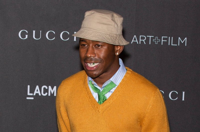 Tyler, The Creator wearing orange sweater and bucket hat in 2019
