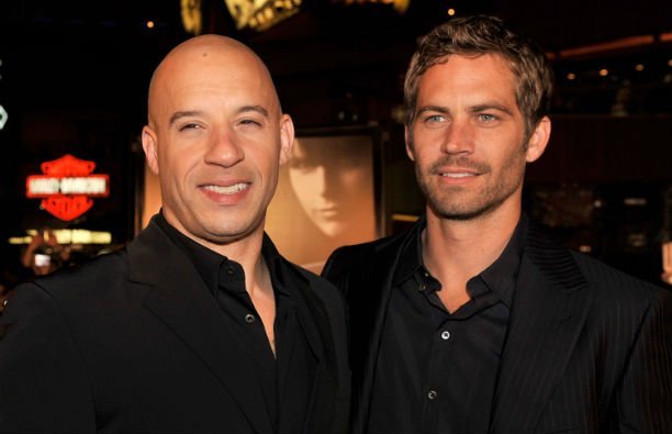 Vin Diesel and Paul Walker, both in black suits, on the red carpet