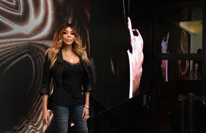 Wendy Williams in a black top and blue jeans