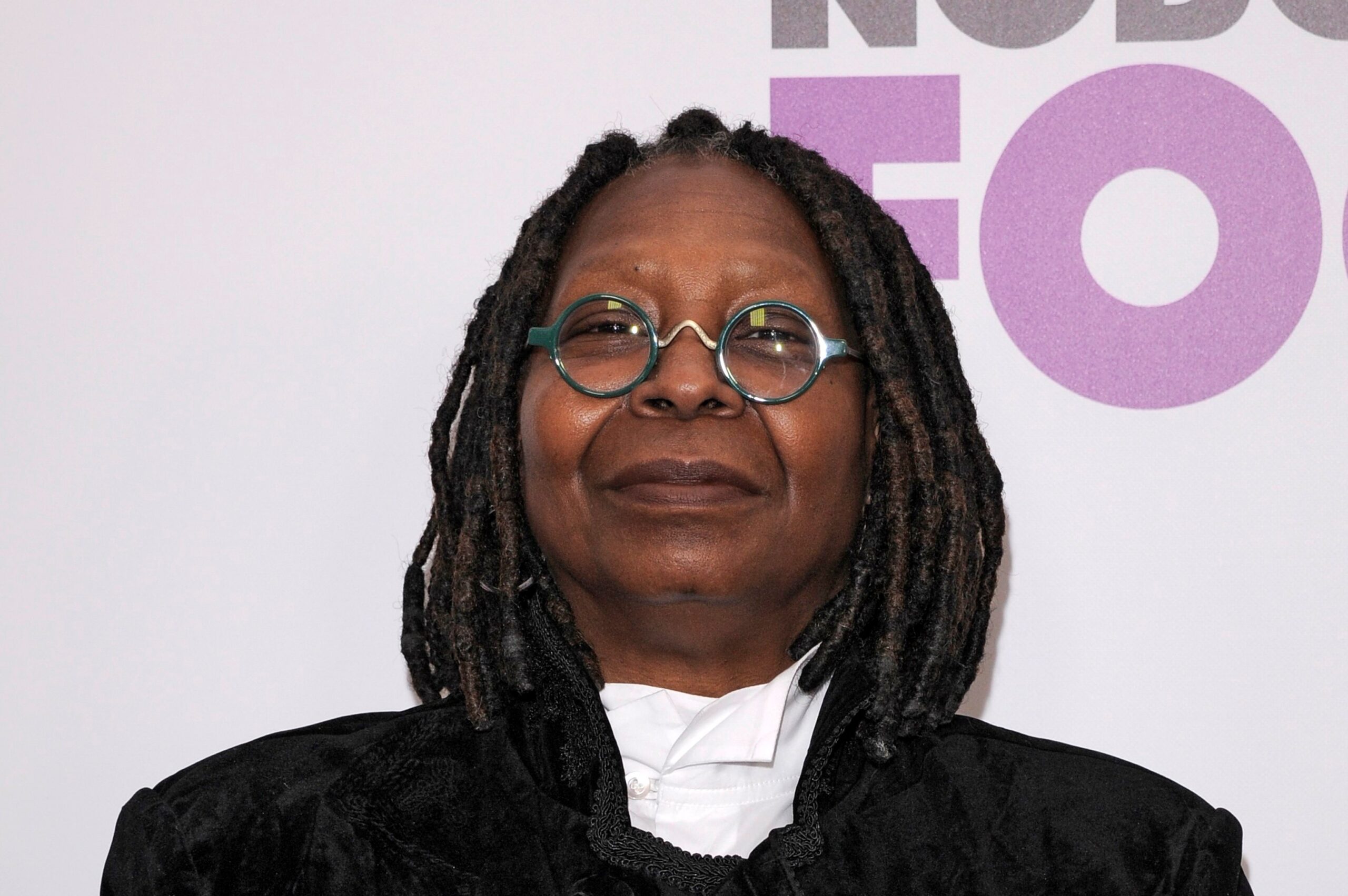 Whoopi Goldberg wearing glasses with green circular frames