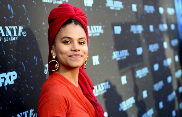 Zazie Beetz in a red top and turban on the red carpet