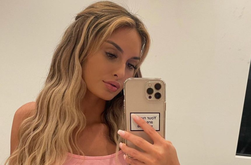 Julia Rose taking a selfie in a pink crop top