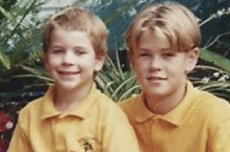 A photo of Chris and Liam Hemsworth as children wearing yellow shirts