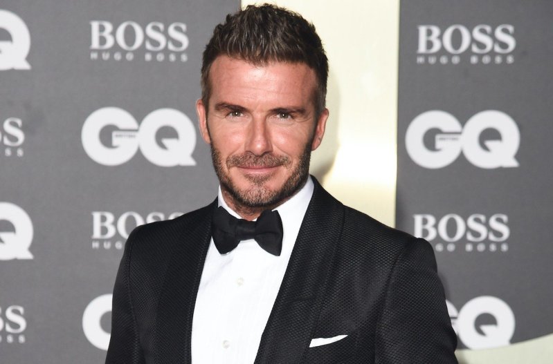 David Beckham smiling in a tuxedo