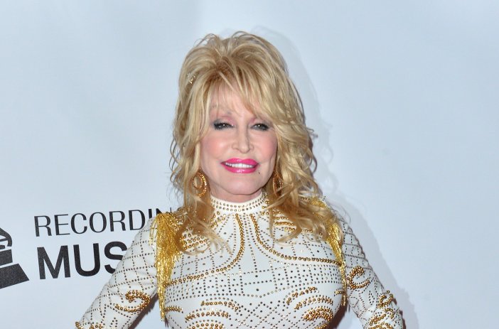 Dolly Parton wearing a white and gold dress at the 2019 MusiCares Person of the Year Gala honoring Dolly Parton at the Los Angeles Convention Centre