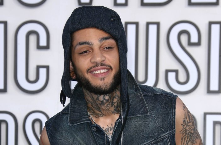 Gym Class Heroes singer Travie McCoy wearing a denim vest and blue knit hat at the 2010 MTV Video Music Awards