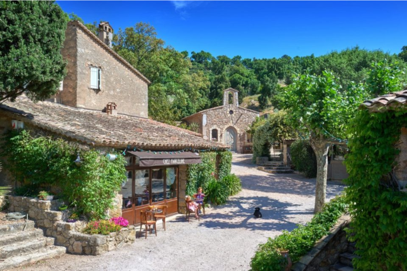 Stone buildings line a walkway in a French village
