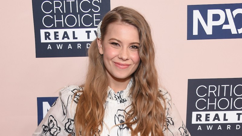 Bindi Irwin smiling in a black and white dress