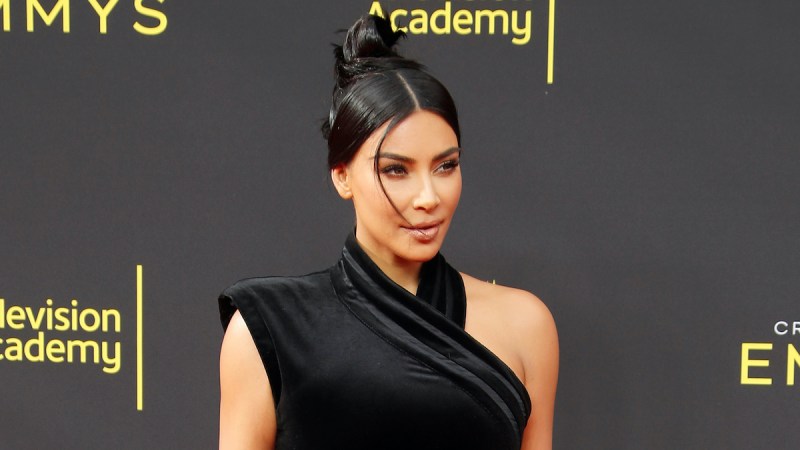 Kim Kardashian in a black dress with her hair up
