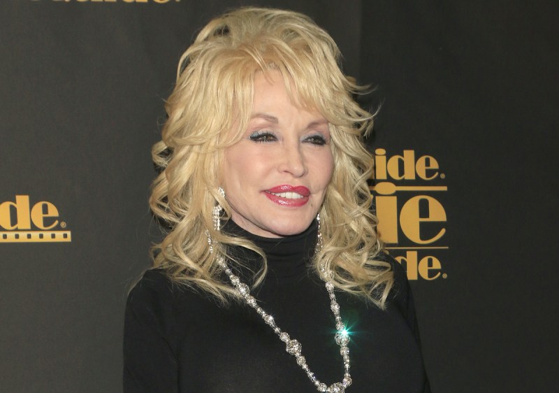 Dolly Parton smiles in a black top
