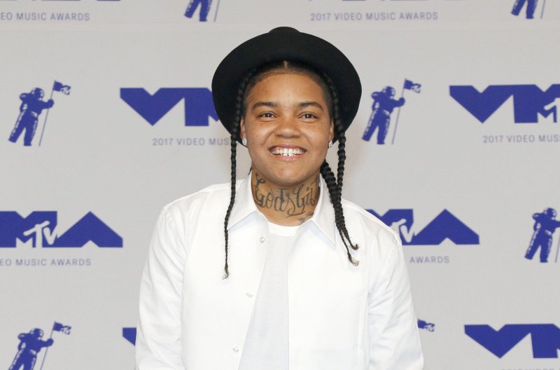 Young M.A wearing a black hat and white shirt at the 2017 MTV Video Music Awards