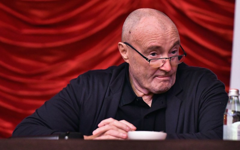 Phil Collins in a black suit