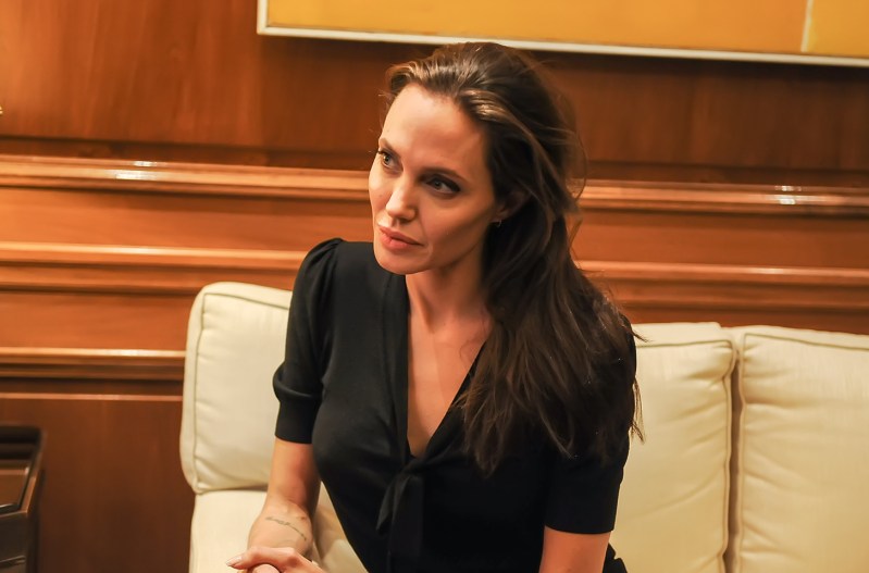 Close up of Angelina Jolie sitting on a couch