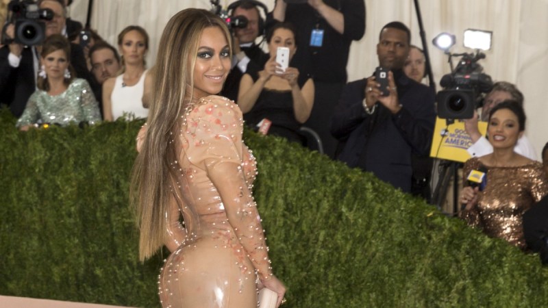 Beyonce wears a fitted peach-colored dress at the Met Gala