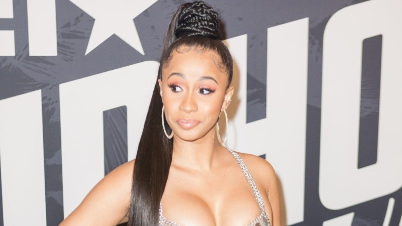 Cardi B wears a silver dress and looks to the side at the BET Awards