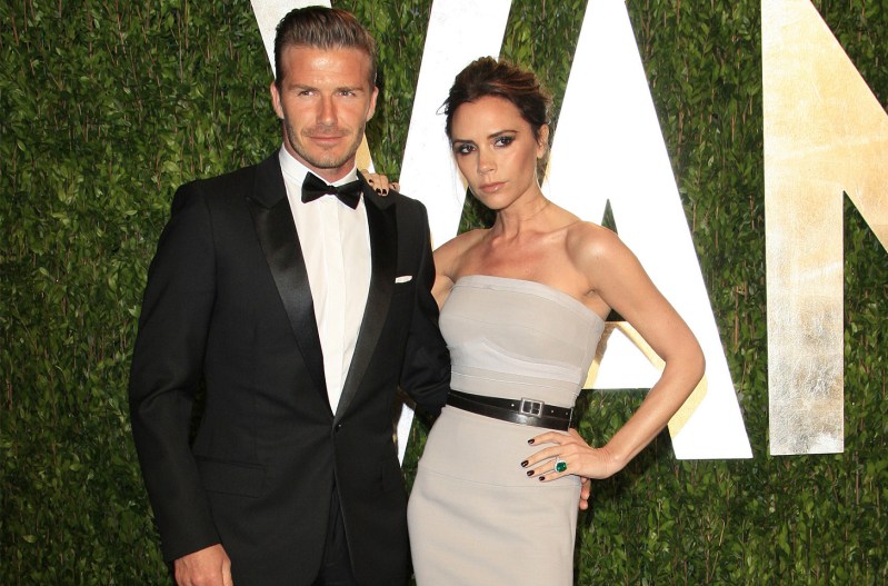 David Beckham on the right in a tuxedo, Victoria Beckham on the right in a gray halter top dress.