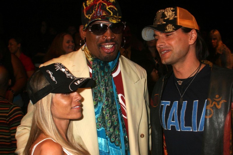 Dennis Rodman in tan cowboy hat standing next to his ex-wife Michelle Moyer