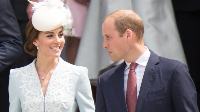 Kate Middleton smiles at Prince William as the two walk down a flight of stone stairs