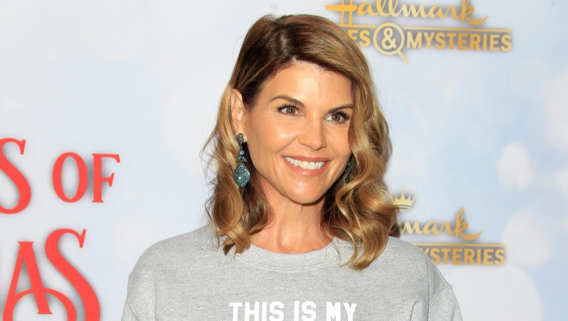 Lori Loughlin smiles in a grey sweater