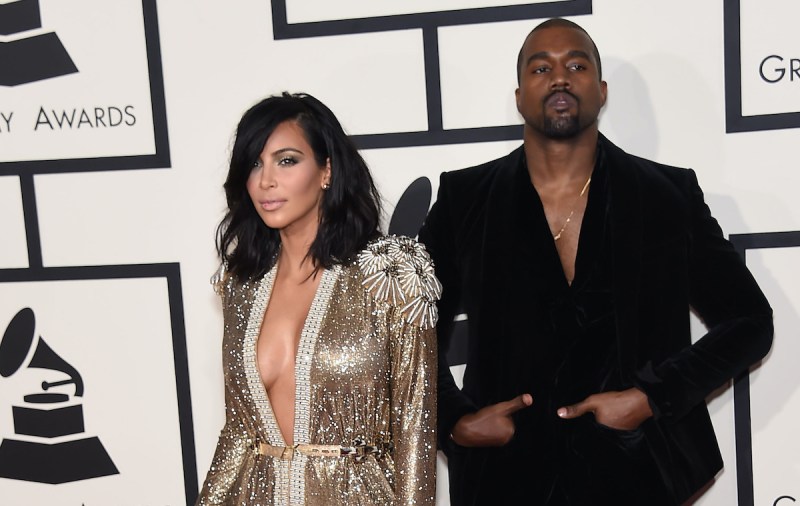 Kim Kardashian in a gold dress with Kanye West in a black suit