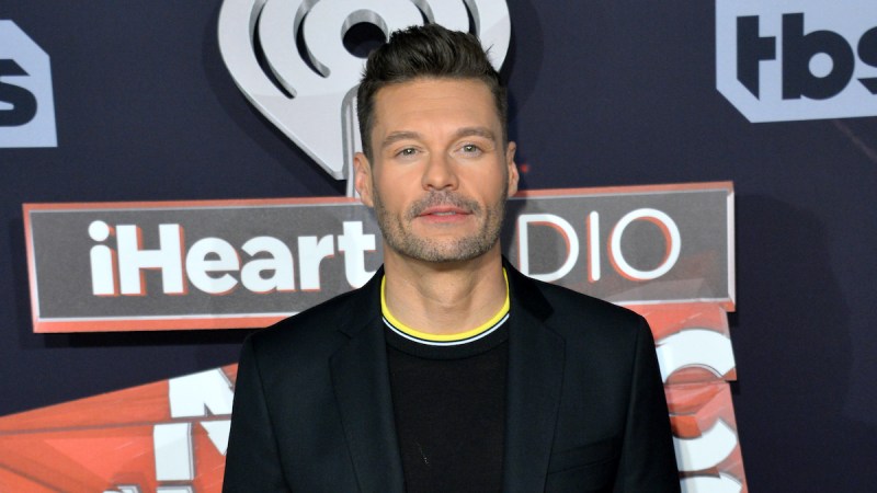 Ryan Seacrest in a suit and sweater
