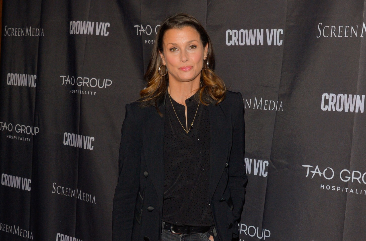 Bridget Moynahan smiling and wearing a black shirt and black blazer.