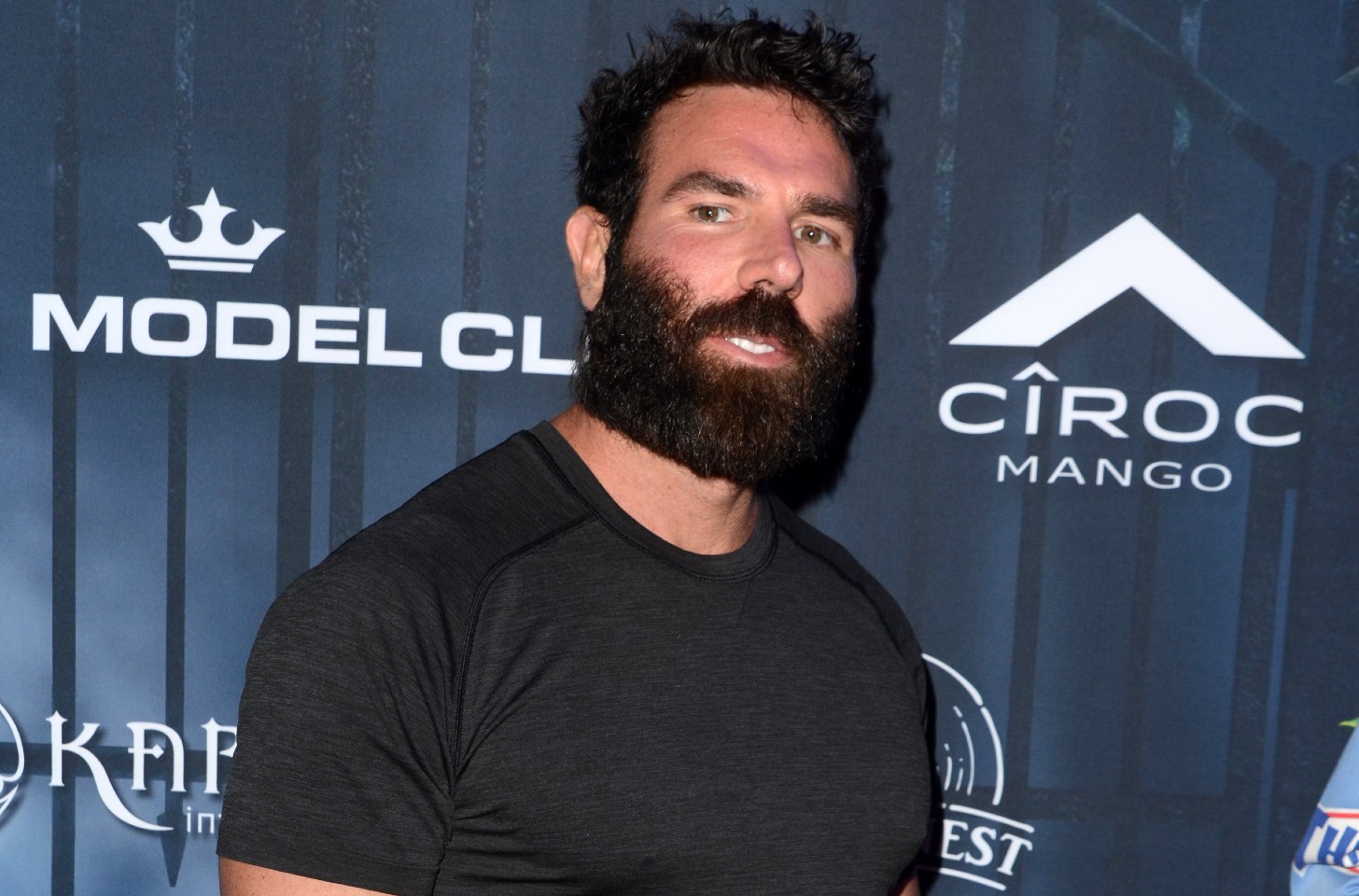 Dan Bilzerian in a black t-shirt.