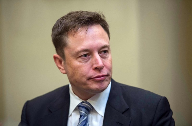 Elon Musk wearing a suit.