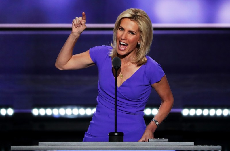 Laura Ingraham wearing a blue dress and delivering a speech with her finger pointed in the air.
