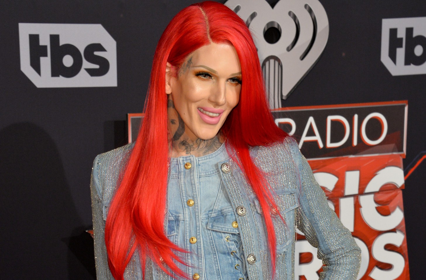 Jeffree Star smiling and wearing a denim jacket.