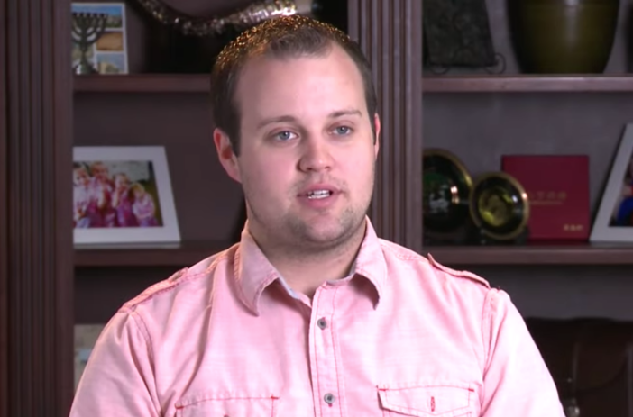 Josh Duggar wearing a pink button-down shirt during a confessional on 19 Kids and Counting