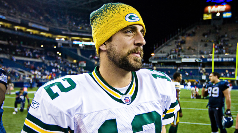 Aaron Rodgers wears his Green Bay Packers uniform and stares off camera