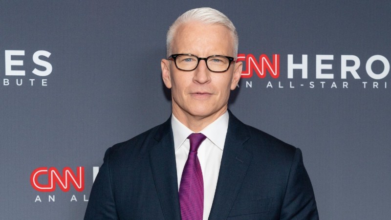 Anderson Cooper wears a dark suit and maroon tie to a CNN Heroes Award Show