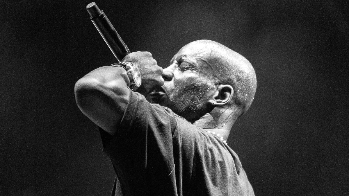 A black and white photo of rapper DMX performing on stage