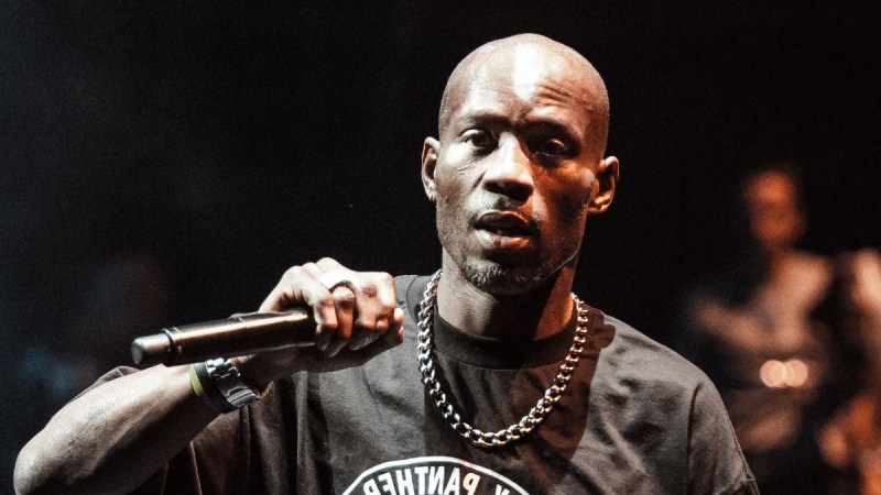 DMX wears a black t shirt on stage as he performs