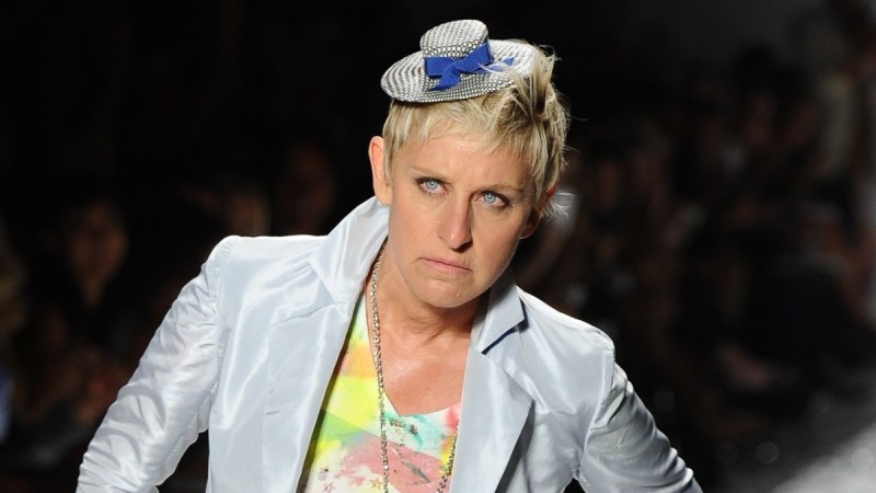 Ellen DeGeneres wears a silver suit and colorful top on the runway