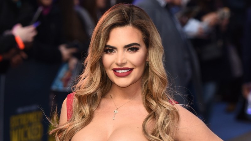 Megan Barton-Hanson wears a low cut red dress to a film premiere in London