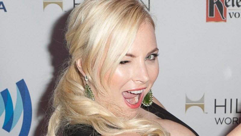 Meghan McCain wears a low cut black dress and winks playfully at the camera