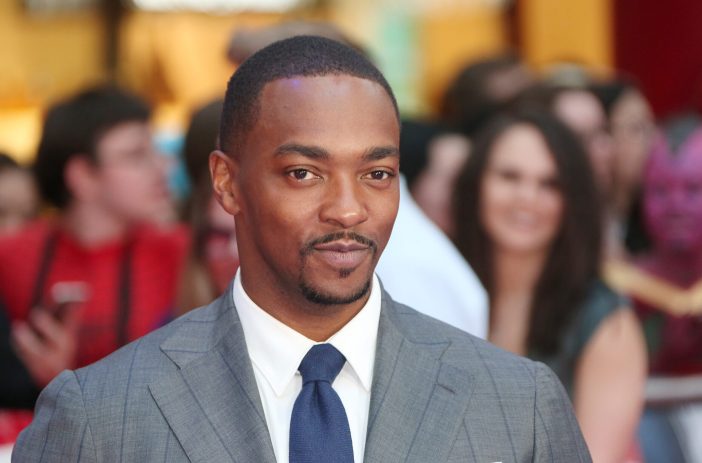 Anthony Mackie wearing a grey suit with blue tie in 2016