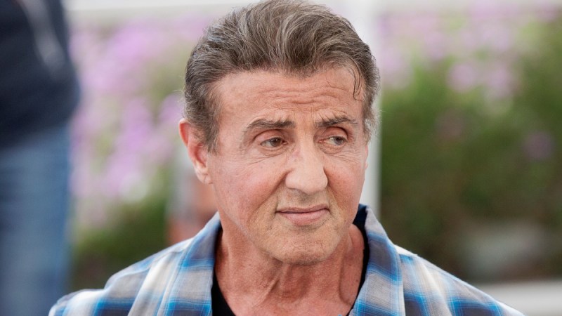 Sylvester Stallone wears a blue plaid shirt at a film festival