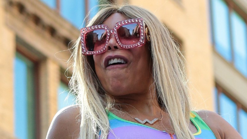 Wendy Williams wears a rainbow dress and pink sunglasses at a Pride Parade